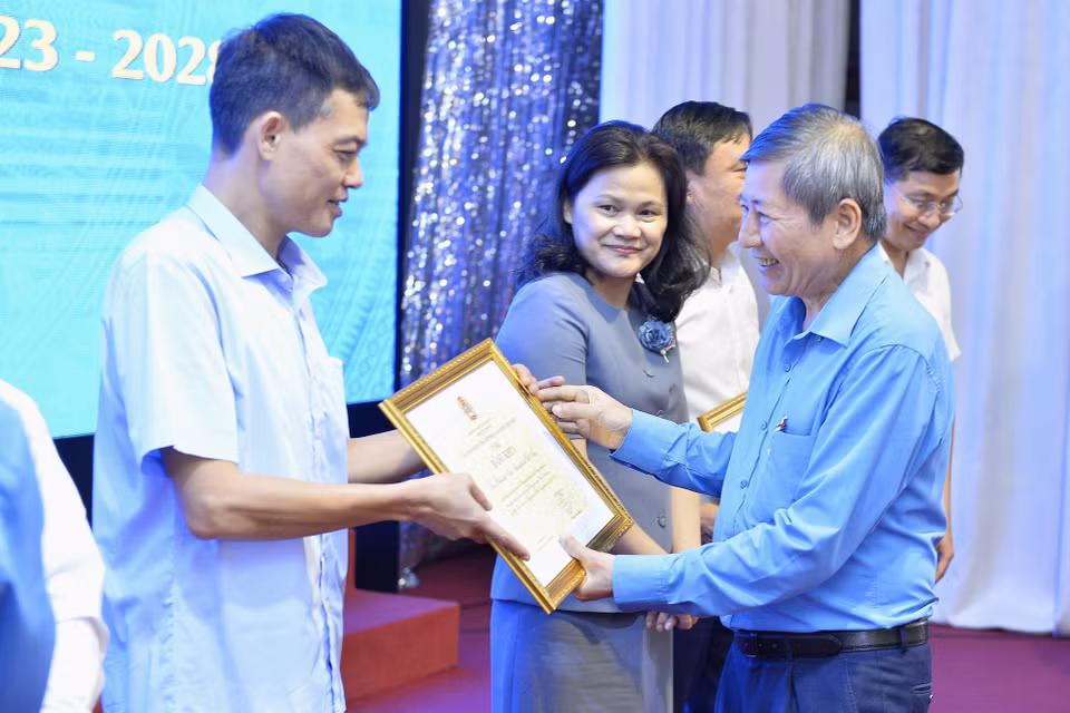 Phó Chủ tịch Tổng Liên đoàn Lao động Việt Nam Trần Thanh Hải trao tặng Bằng khen của Chủ tịch Tổng Liên đoàn Lao động Việt Nam cho 4 tập thể và 3 cá nhân của TTXVN. (Ảnh: Minh Đức/TTXVN)