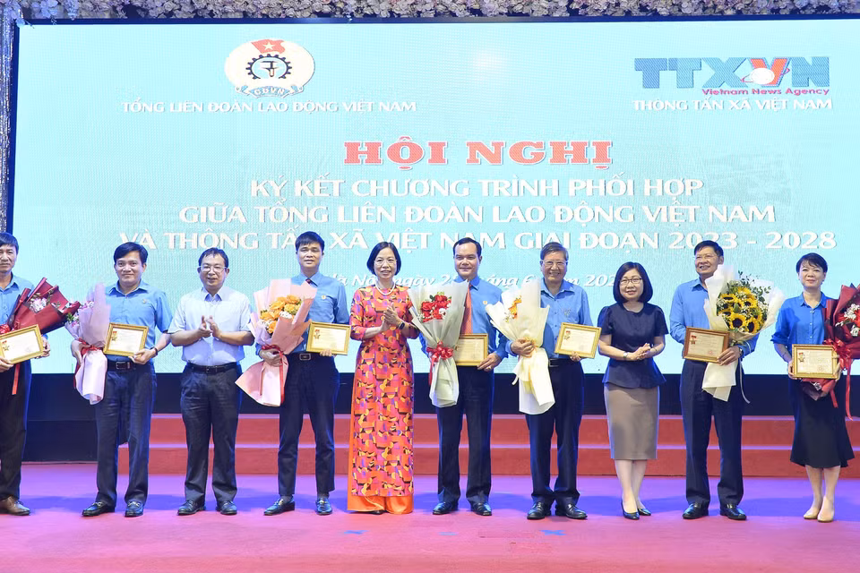 Tổng Giám đốc TTXVN Vũ Việt Trang trao tặng Kỷ niệm chương "Vì sự nghiệp Thông tấn xã Việt Nam" cho Chủ tịch Tổng Liên đoàn Lao động Việt Nam Nguyễn Đình Khang và một số cán bộ của Tổng Liên đoàn Lao động Việt Nam. (Ảnh: Minh Đức/TTXVN)