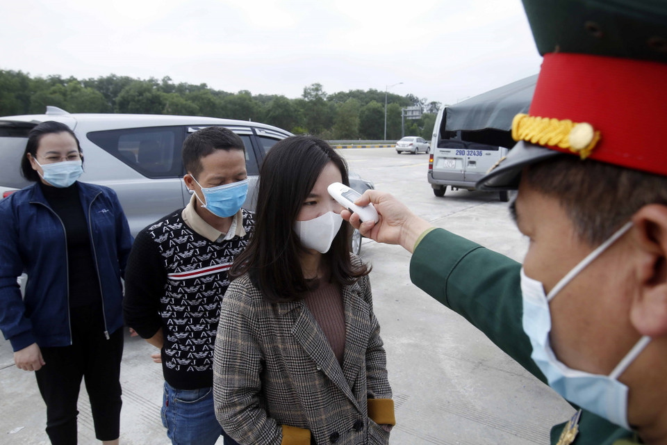 Lưc lượng liên ngành kiểm tra thân nhiệt với các hành khách muốn vào địa bàn tỉnh Hưng Yên. (Ảnh: Phạm Kiên/TTXVN)