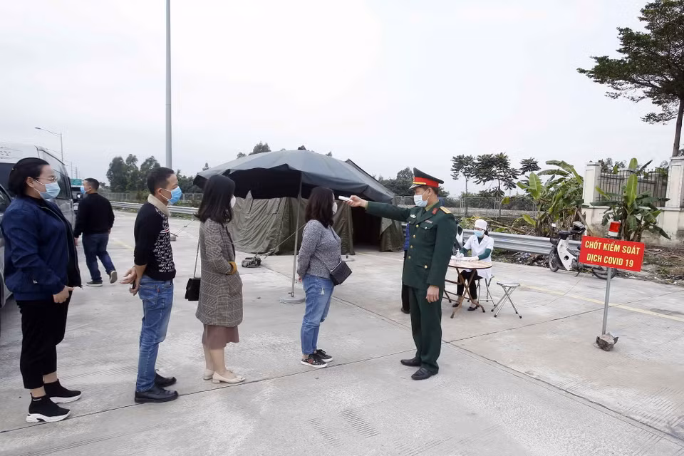 Lưc lượng liên ngành kiểm tra thân nhiệt với các hành khách muốn vào địa bàn tỉnh Hưng Yên. (Ảnh: Phạm Kiên/TTXVN)
