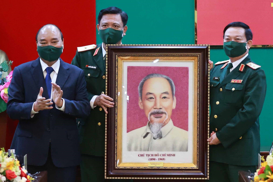 Chủ tịch nước Nguyễn Xuân Phúc, Chủ tịch Hội đồng Quốc phòng An ninh tặng chân dung Chủ tịch Hồ Chí Minh cho Bộ Tư lệnh Quân khu 7. (Ảnh: Thống Nhất/TTXVN)