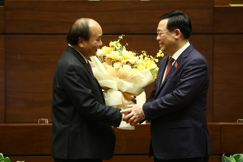 Chủ tịch Quốc hội Vương Đình Huệ chúc mừng Thủ tướng Nguyễn Xuân Phúc hoàn thành xuất sắc nhiệm vụ. (Ảnh: Văn Điệp/TTXVN)