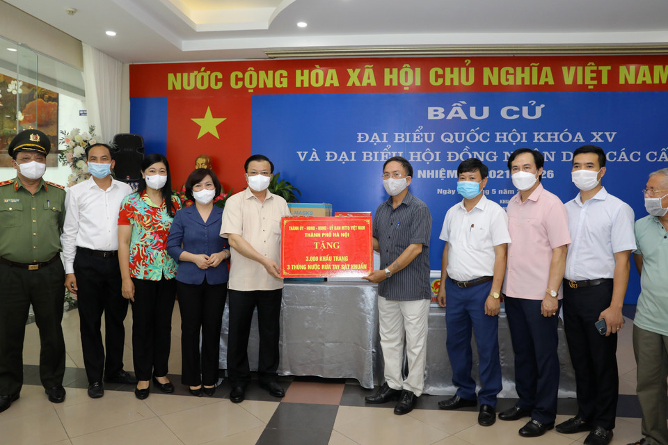 Bí thư Thành ủy Hà Nội Đinh Tiến Dũng trao quà hỗ trợ phòng, chống dịch bệnh COVID-19 tại Khu vực bỏ phiếu số 8, phường Phú Thượng, quận Tây Hồ, Hà Nội. (Ảnh: Nguyễn Điệp/TTXVN)