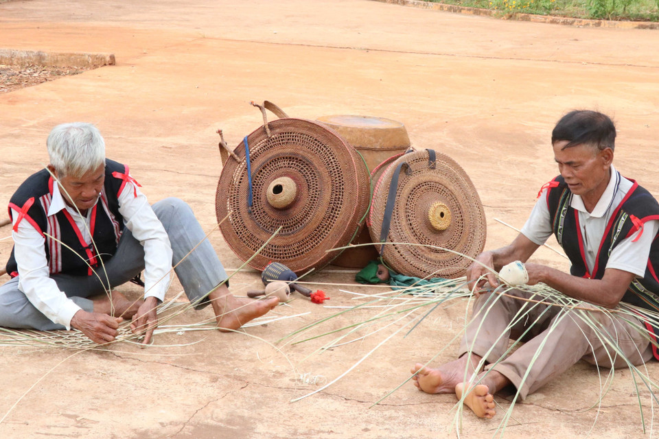 Các nghệ nhân làng Mít Jep, xã Ia O (Ia Grai, Gia Lai) đan áo cho cồng, chiêng. (Ảnh: Hồng Điệp/TTXVN)