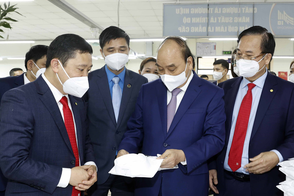 Hình ảnh Chủ tịch nước Nguyễn Xuân Phúc thăm dây chuyền sản xuất của Tổng công ty May 10. (Ảnh: Thống Nhất/TTXVN)