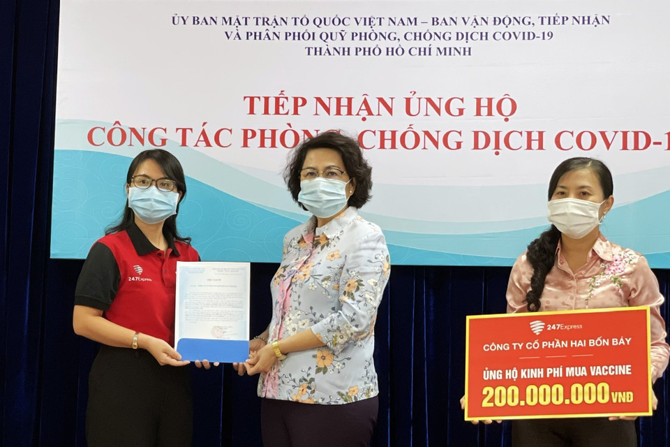 Bà Tô Thị Bích Châu, Chủ tịch Ủy ban MTTQ Việt Nam Thành phố Hồ Chí Minh (giữa) tiếp nhận kinh phí ủng hộ mua vaccine phòng, chống COVID-19 từ đại diện các doanh nghiệp, tổ chức (3/6/2021). (Ảnh: Xuân Khu/TTXVN)