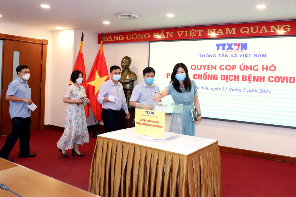 Lãnh đạo, cán bộ, phóng viên, biên tập viên và người lao động của Thông tấn xã Việt Nam tham gia quyên góp, ủng hộ Quỹ phòng, chống dịch COVID-19. (Ảnh: Phạm Kiên/TTXVN)
