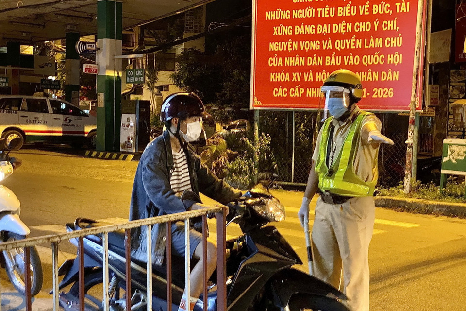 Lực lượng cảnh sát giao thông yêu cầu người dân dừng xe khai báo y tế trên đường Lê Quang Định (phường 1, quận Gò Vấp, Thành phố Hồ Chí Minh). (Ảnh: Hồng Giang/TTXVN)