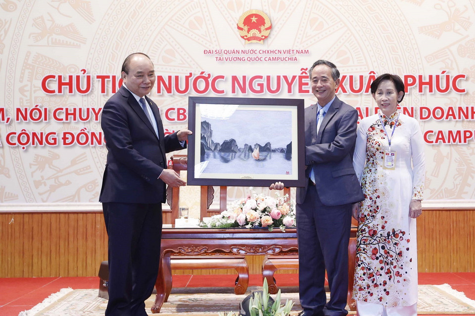 Chủ tịch nước Nguyễn Xuân Phúc trao quà tặng cho cộng đồng Việt Nam tại Campuchia. (Ảnh: Thống Nhất/TTXVN)