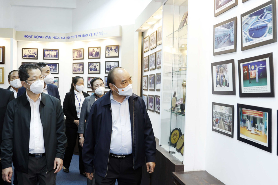 Chủ tịch nước Nguyễn Xuân Phúc tham quan Phòng truyền thống của công ty. (Ảnh: Thống Nhất/TTXVN)