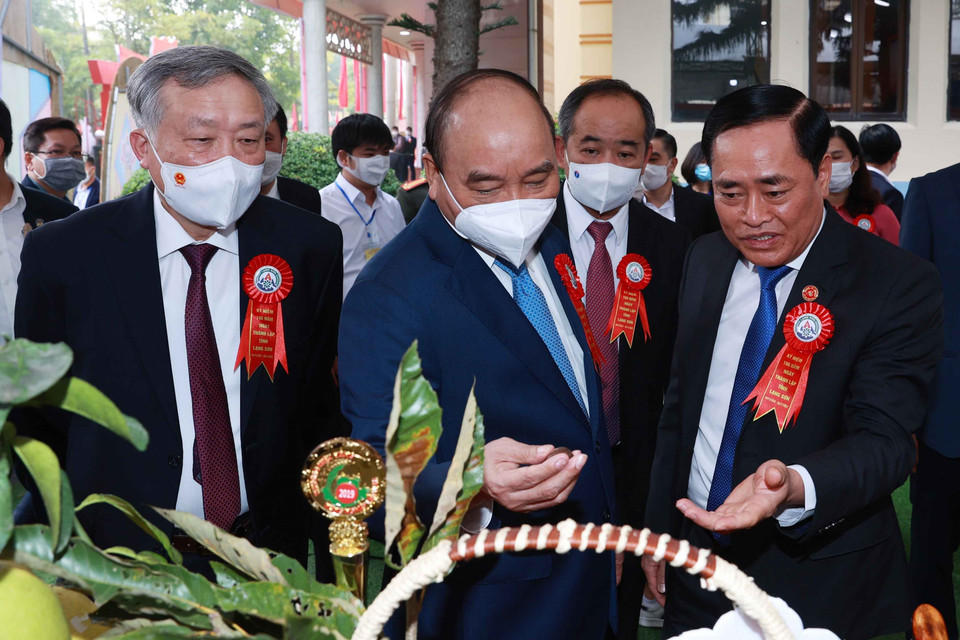 Chủ tịch nước Nguyễn Xuân Phúc và các đại biểu tham quan Triển lãm thành tựu kinh tế-xã hội tỉnh Lạng Sơn năm 2021.(Ảnh: Thống Nhất/TTXVN)