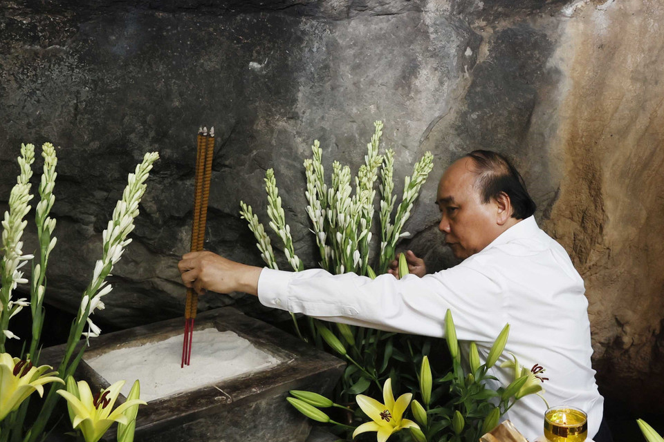 Chủ tịch nước Nguyễn Xuân Phúc dâng hương tại Hang 8 thanh niên xung phong nhân kỷ niệm 50 năm Ngày hy sinh các liệt sỹ Thanh niên xung phong tại đường 20 Quyết Thắng. (Ảnh: Thống Nhất/TTXVN)