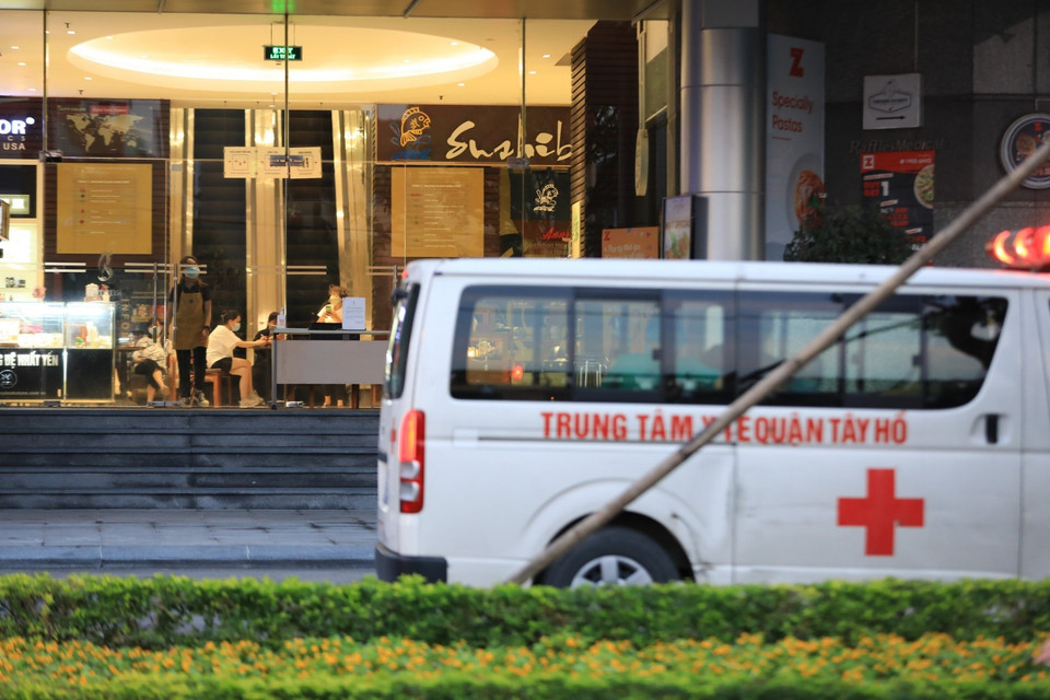 Chiều 29/5, lực lượng chức năng Trung tâm Y tế quận Tây Hồ có mặt tại tòa nhà Fraser Suites để tiến hành các thủ tục đưa bệnh nhân đi cách ly y tế tập trung. (Ảnh: Thành Đạt/TTXVN)