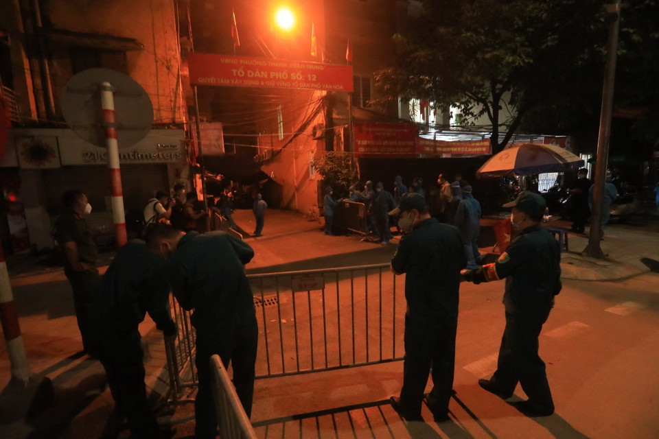 Lực lượng dân quân tự vệ quận Thanh Xuân gỡ bỏ rào chắn tại ngõ 328, 330 đường Nguyễn Trãi. (Ảnh: Tuấn Anh/TTXVN)