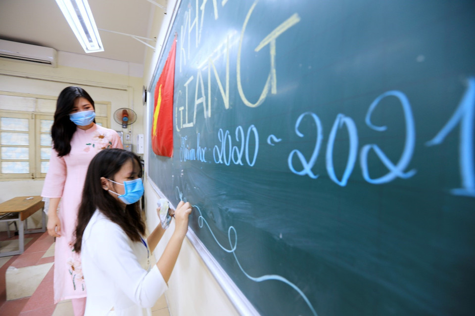 Khối lớp 11 trường THPT Việt Đức, quận Hoàn Kiếm (Hà Nội) đeo khẩu trang nghiêm túc thực hiện lễ khai giảng năm học mới 2020-2021. (Ảnh: Thành Đạt/TTXVN)