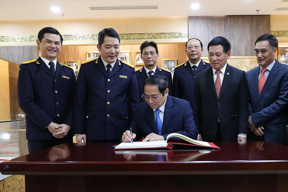 Thủ tướng Phạm Minh Chính viết lưu bút tại Phòng truyền thống của Tổng Cục thuế. (Ảnh: Dương Giang/TTXVN)