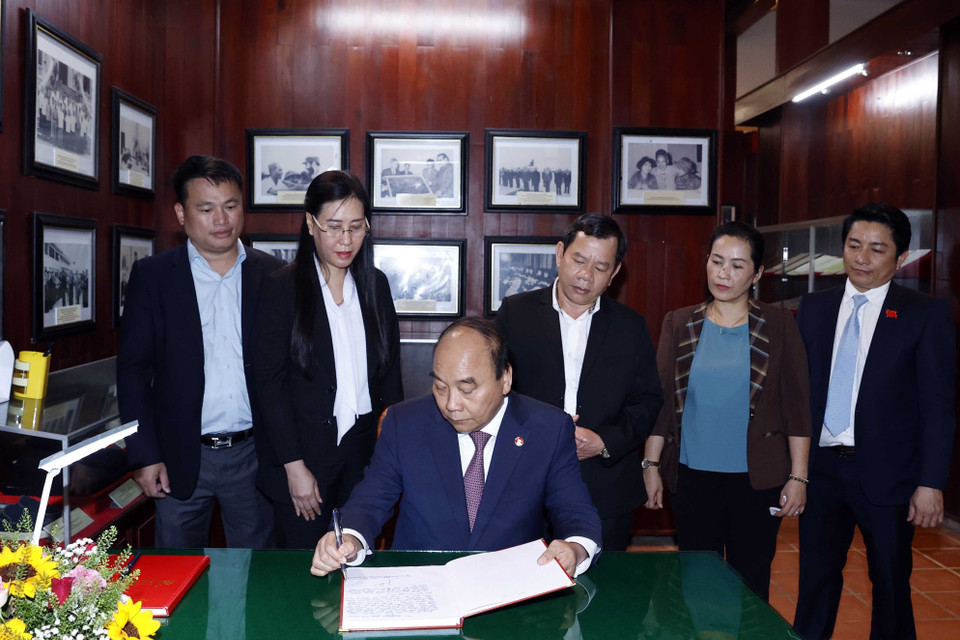 CChủ tịch nước Nguyễn Xuân Phúc viết lưu bút tại Khu lưu niệm cố Thủ tướng Phạm Văn Đồng. (Ảnh: Thống Nhất/TTXVN)