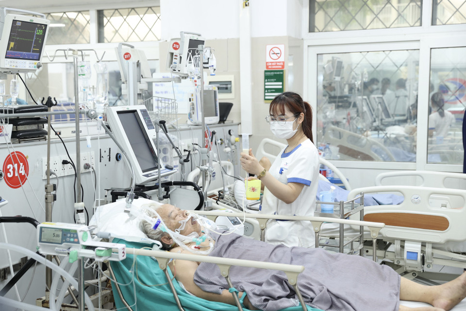 Nhân viên y tế chăm sóc sức khỏe bệnh nhân đang điều trị tại Bệnh viện Bạch Mai. (Ảnh: Dương Giang/TTXVN)