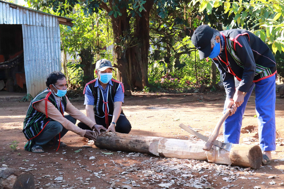 Để tạc được bức tượng như ý cho làng, các nghệ nhân thường bàn bạc, thống nhất ý kiến với nhau. (Ảnh: Hồng Điệp/TTXVN)
