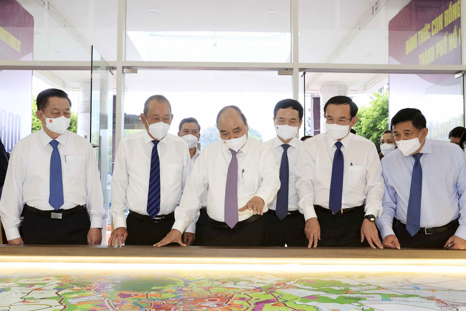 Chủ tịch nước Nguyễn Xuân Phúc xem bản đồ quy hoạch phát triển hai huyện Hóc Môn và Củ Chi. (Ảnh: Thống Nhất/TTXVN)