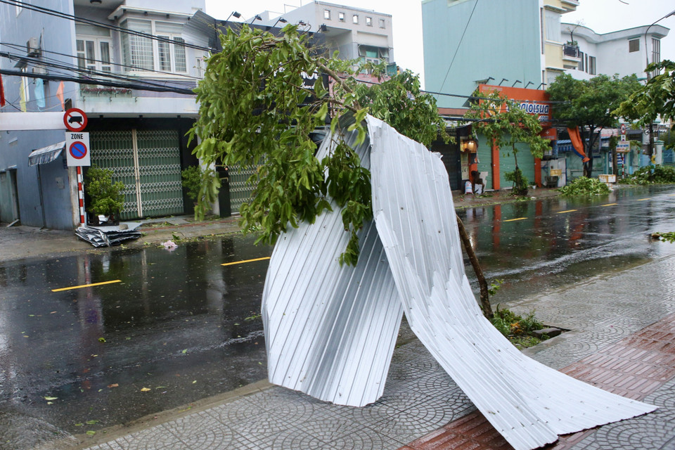 Gió giật mạnh khiến tôn của các gia đình bay xuống đường Trần Cao Vân ở Đà Nẵng. (Ảnh Trần Lê Lâm/TTXVN)