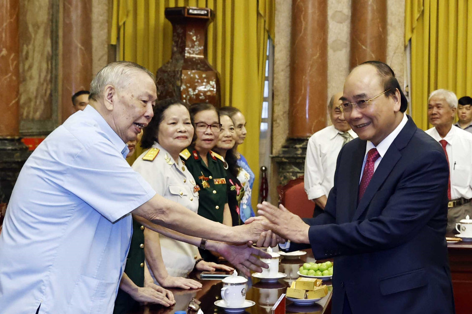 Chủ tịch nước và các cán bộ từng trực tiếp phục vụ và bảo vệ Bác Hồ. (Ảnh: Thống Nhất/TTXVN)