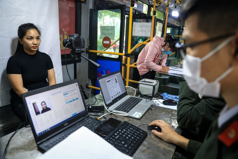 Các công đoạn lấy dấu vân tay điện tử, chụp ảnh thẻ được thực hiện ngay trong xe buýt lưu động. (Ảnh: Thành Đạt/TTXVN)