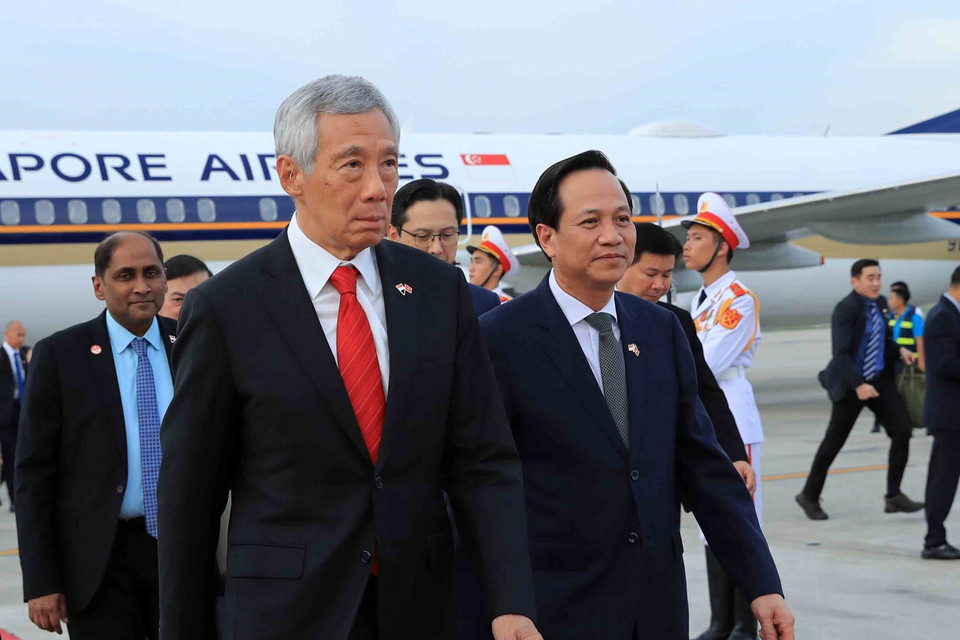 Bộ trưởng Bộ Lao động, Thương binh và Xã hội Đào Ngọc Dung và các đại biểu đón Thủ tướng nước Cộng hòa Singapore Lý Hiển Long tại Sân bay Quốc tế Nội Bài. (Ảnh: An Đăng/TTXVN)