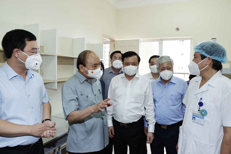 Chủ tịch nước Nguyễn Xuân Phúc thăm hỏi, tặng quà các nhân viên y tế cơ sở thu dung, điều trị bệnh nhân mắc COVID-19 của Bệnh viện Đa khoa Hà Đông. (Ảnh: Thống Nhất/TTXVN) 