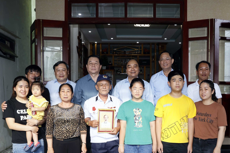 Chủ tịch nước Nguyễn Xuân Phúc thăm, tặng quà thương binh Nguyễn Thống tại thôn Mỹ Cảnh, xã Bảo Ninh, thành phố Đồng Hới. (Ảnh: Thống Nhất/TTXVN)