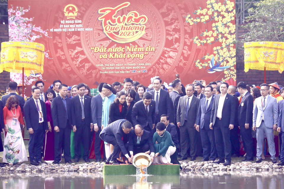 Chủ tịch nước Nguyễn Xuân Phúc và Phu nhân cùng các đại biểu kiều bào thả cá chép tiễn ông Công, ông Táo theo phong tục truyền thống. (Ảnh: Lâm Khánh/TTXVN)