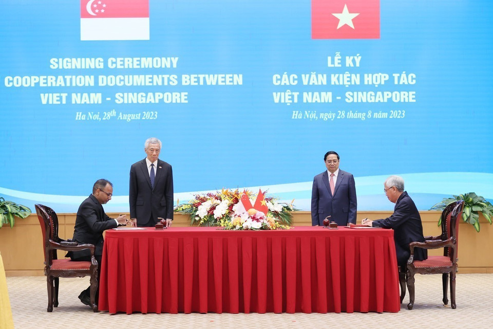Thủ tướng Phạm Minh Chính và Thủ tướng Singapore Lý Hiển Long chứng kiến ký Bản ghi nhớ về thúc đẩy phát triển cơ sở hạ tầng bền vững tại Thành phố Hồ Chí Minh giữa Ủy ban Nhân dân Thành phố Hồ Chí Minh và Cơ quan Hạ tầng châu Á, Singapore. (Ảnh: Dương Giang/TTXVN)