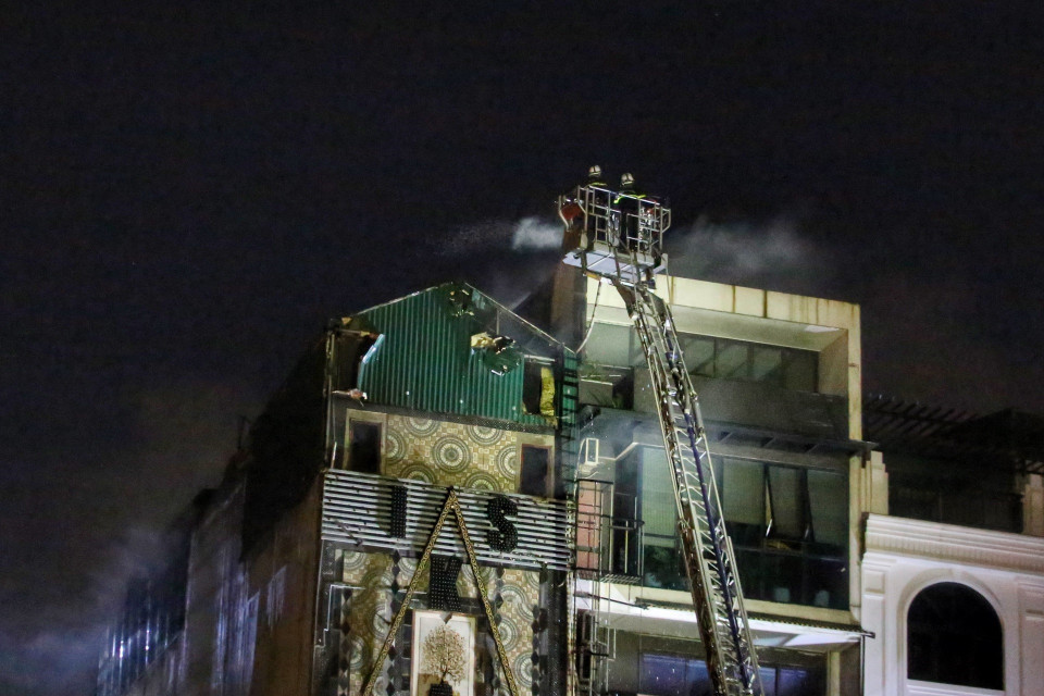 Cảnh sát Phòng cháy chữa cháy và Cứu nạn cứu hộ tiếp tục khống chế vụ cháy (ảnh chụp lúc 19h30). (Ảnh: Tuấn Đức/TTXVN)