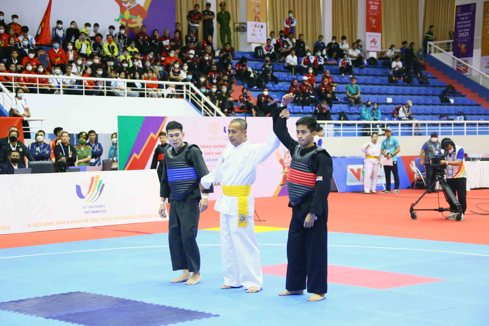 VĐV Muhammad Khairi Adib Bin Azhar (Malayxia-giáp đỏ) giành chiến thắng chung cuộc trước VĐV Bo Thamma Vongsa (Lào) ở hạng cân 50kg-55kg. (Ảnh: Quang Quyết/TTXVN)