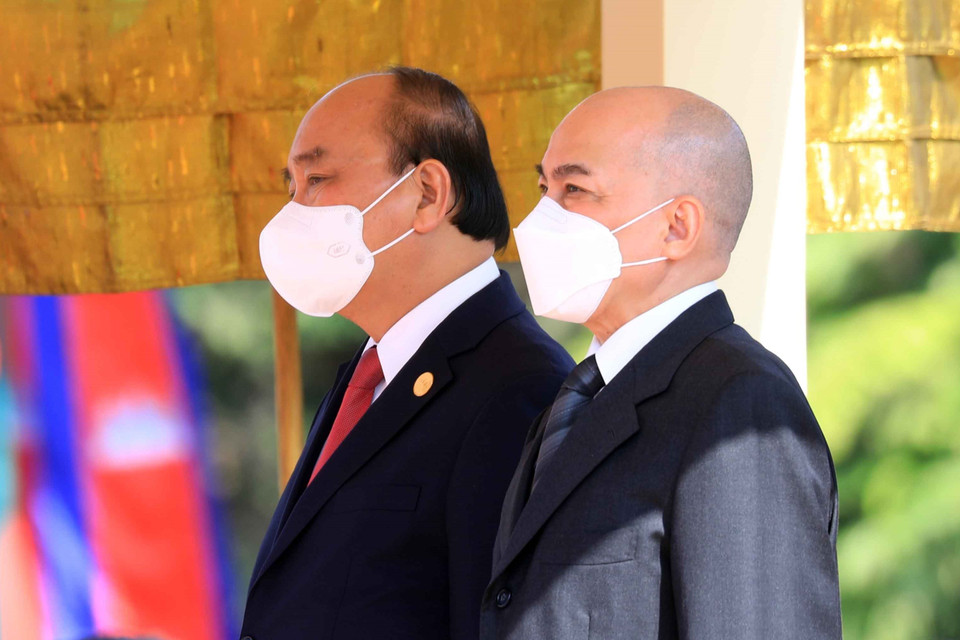 Chủ tịch nước Nguyễn Xuân Phúc và Quốc vương Campuchia Norodom Sihamoni nghe quân nhạc cử Quốc thiều 2 nước tại lễ đón. (Ảnh: Thống Nhất/TTXVN)