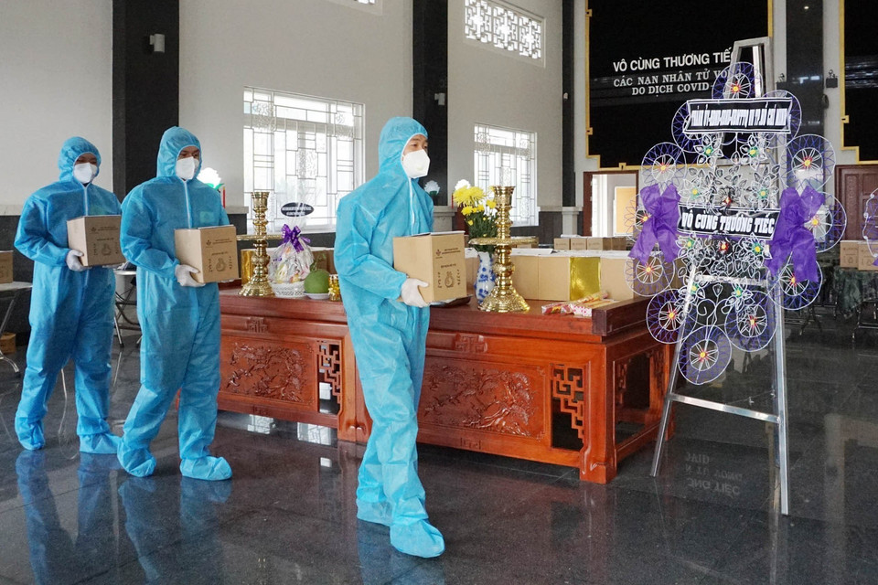 Cán bộ, chiến sỹ Ban Chỉ huy quân sự quận Bình Chánh tiếp nhận tro cốt người mất vì COVID-19 để chuyển về cho nhân thân. (Ảnh: Xuân Khu-TTXVN)