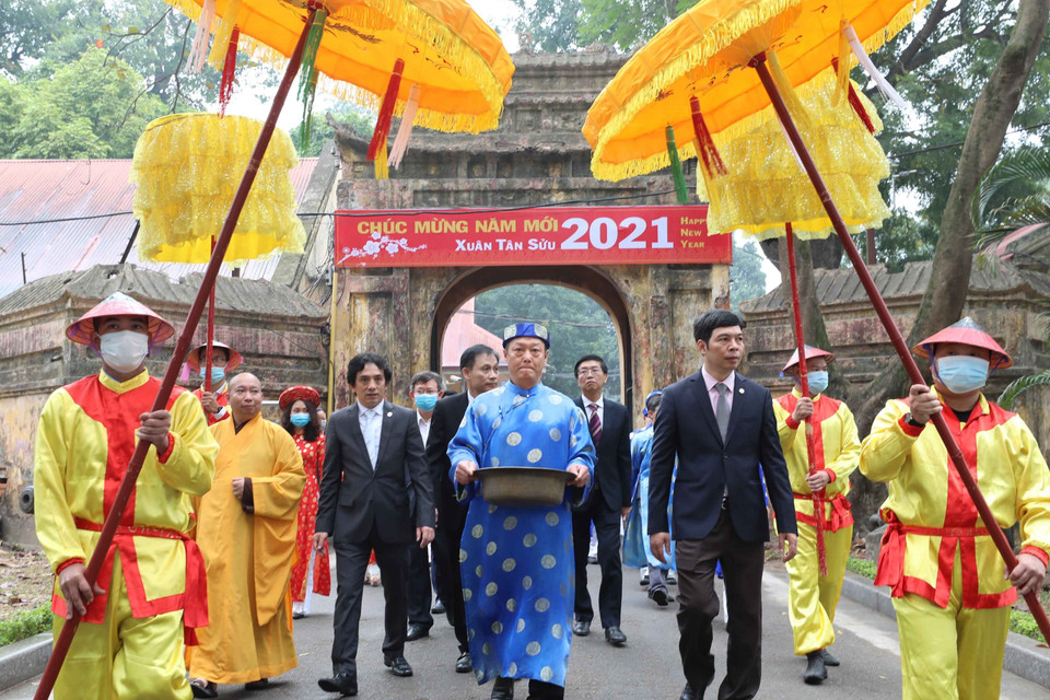 Đoàn hành lễ mang cá chép đi thả. (Ảnh: Thanh Tùng/TTXVN)