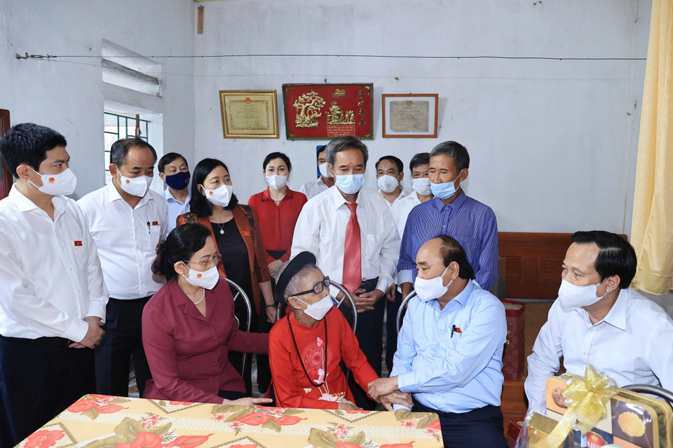 Chủ tịch nước Nguyễn Xuân Phúc đến thăm hỏi và tặng quà cho Mẹ Việt Nam Anh hùng Nguyễn Thị Mờn. (Ảnh: Thống Nhất/TTXVN)