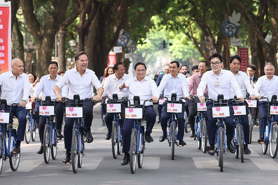 Thủ tướng Phạm Minh Chính và Thủ tướng Hà Lan Mark Rutte đạp xe tham quan không gian của Thủ đô. (Ảnh: Dương Giang/TTXVN)