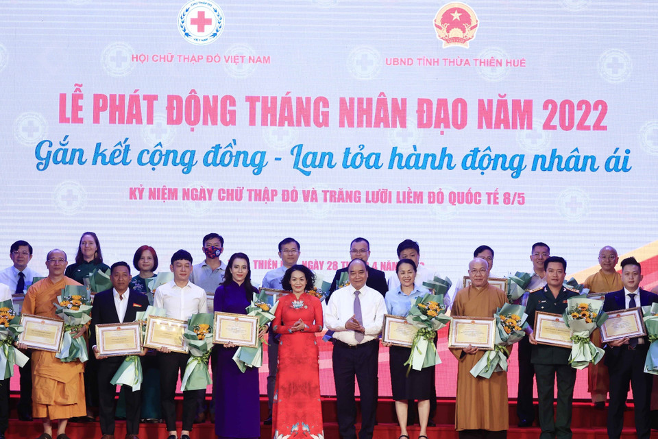 Chủ tịch nước tặng hoa cho các nhà tài trợ. (Ảnh: Thống Nhất/TTXVN)