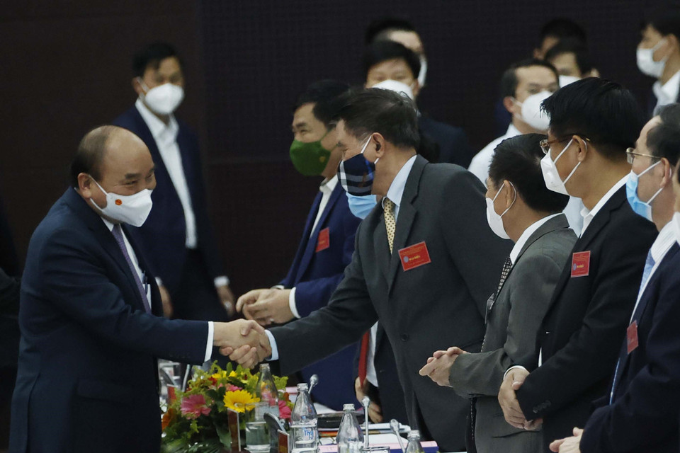 Chủ tịch nước Nguyễn Xuân Phúc với các đại biểu tham dự hội thảo. (Ảnh: Thống Nhất/TTXVN)