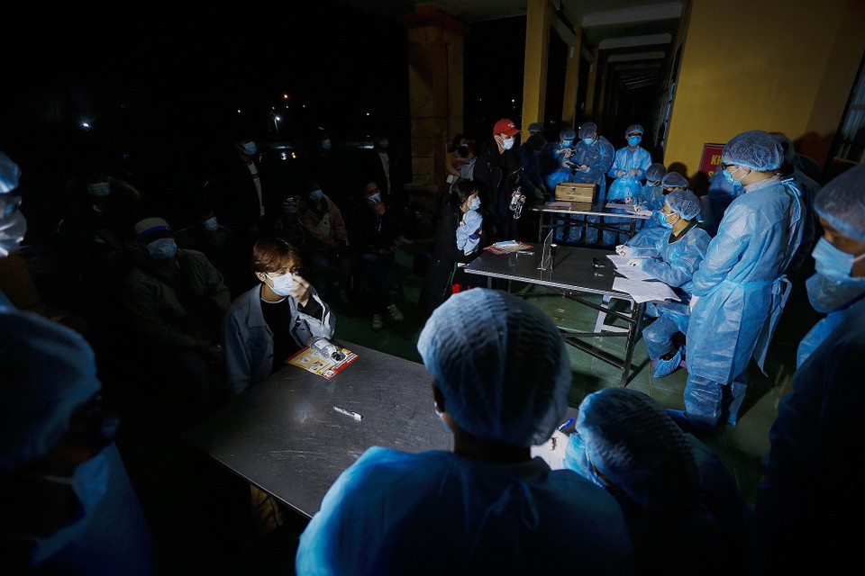 Công tác kiểm tra sức khỏe, rà soát tên tuổi và điểm đến tại vùng dịch Hàn Quốc của mỗi công dân được các cán bộ, y bác sỹ thực hiện chặt chẽ, đúng quy định trước khi đưa công dân vào các điểm cách ly khác nhau theo từng mức độ. (Ảnh: Trọng Đạt/TTXVN)