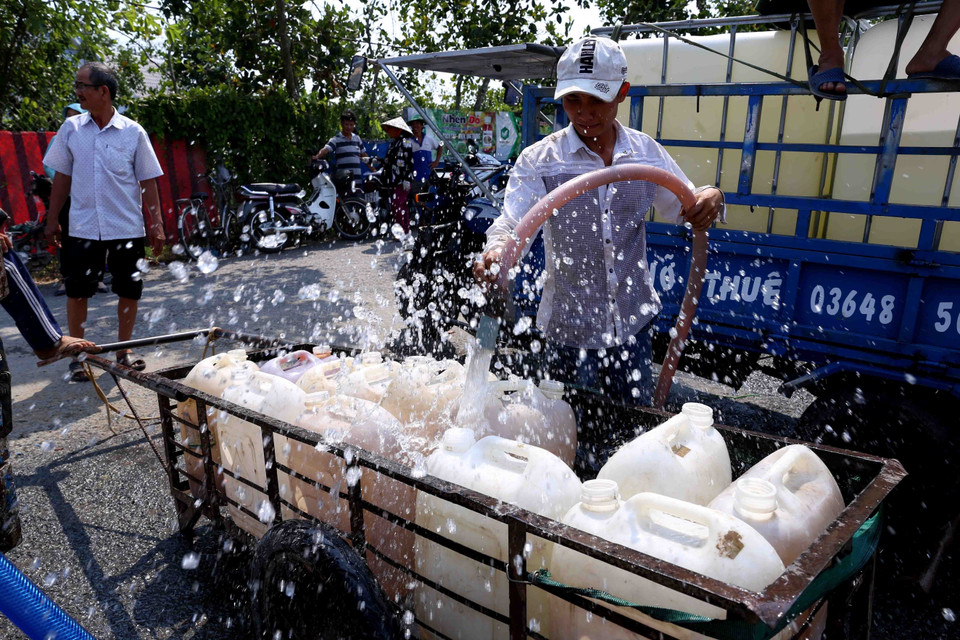  Người dân trên địa bàn xã Thanh Hòa, thị xã Cai Lậy (Tiền Giang) lấy nước ngọt miễn phí tại điểm cung cấp nước ngọt cầu Ông Thiệm. (Ảnh: TTXVN)