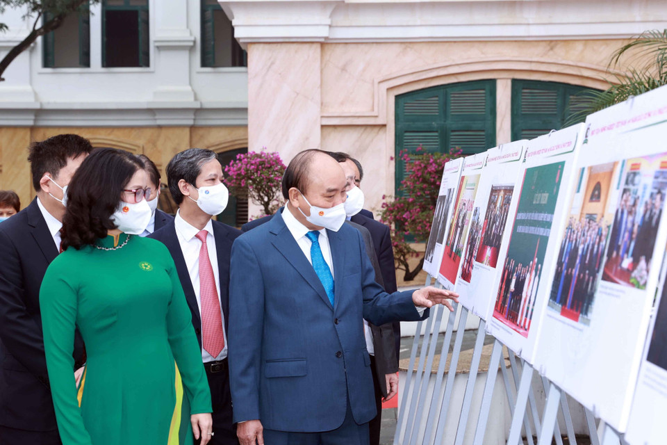 Chủ tịch nước Nguyễn Xuân Phúc xem trưng bày ảnh do Thông tấn xã Việt Nam và Học viện Nông nghiệp Việt Nam phối hợp tổ chức. (Ảnh: Thống Nhất/TTXVN)