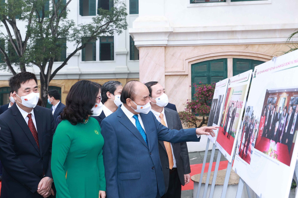 Chủ tịch nước Nguyễn Xuân Phúc xem trưng bày ảnh do Thông tấn xã Việt Nam và Học viện Nông nghiệp Việt Nam phối hợp tổ chức. (Ảnh: Thống Nhất/TTXVN)