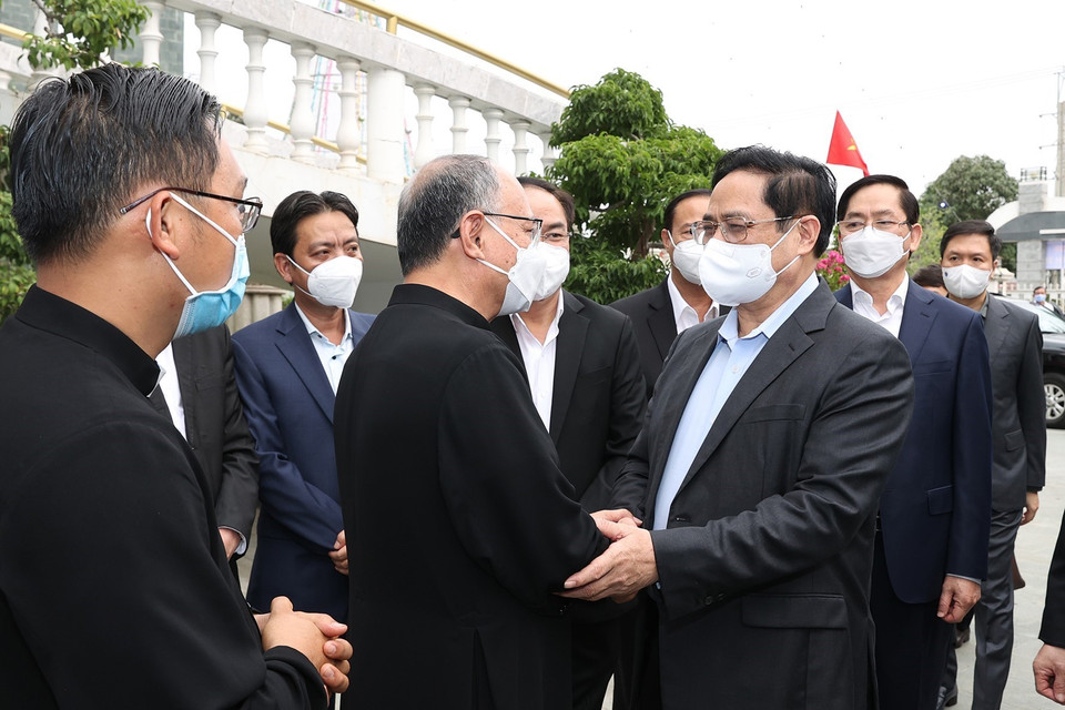 Thủ tướng Phạm Minh Chính thăm hỏi các giáo dân giáo xứ Long Hương nhân dịp Lễ Giáng sinh 2021. (Ảnh: Dương Giang/TTXVN)