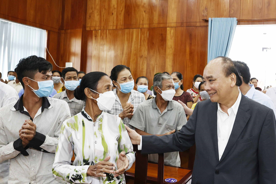 Chủ tịch nước Nguyễn Xuân Phúc hỏi thăm hộ nghèo, công nhân lao động có hoàn cảnh khó khăn, người nhiễm chất độc da cam tại huyện Châu Thành. (Ảnh: Thống Nhất/TTXVN)