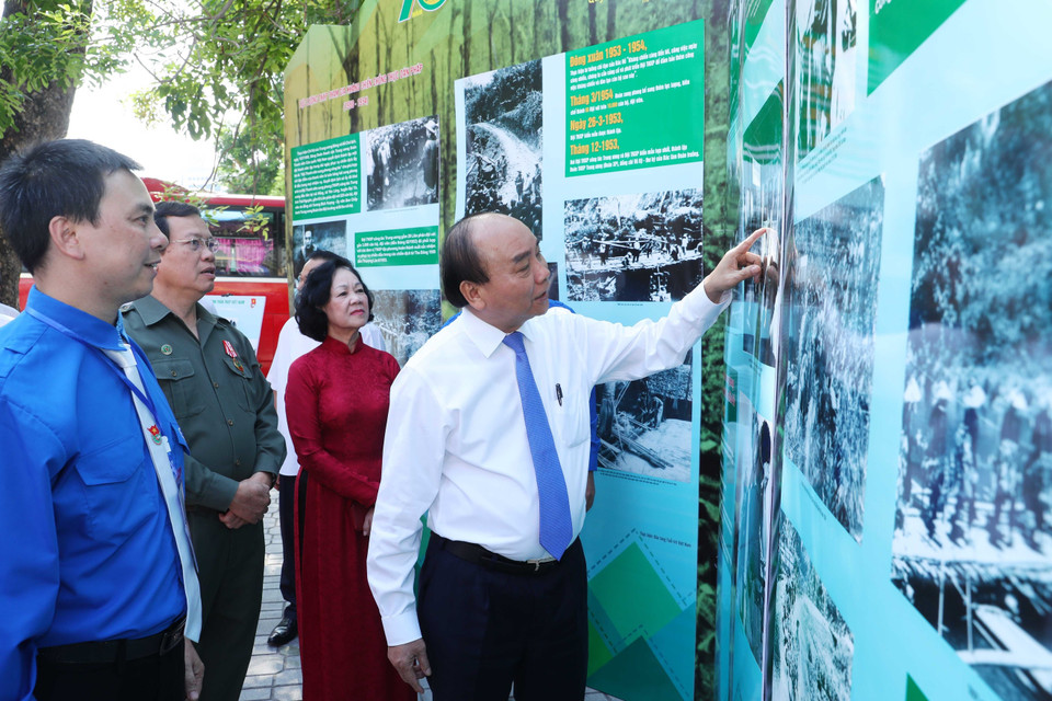 Thủ tướng Nguyễn Xuân Phúc thăm không gian trưng bày hình ảnh về lực thượng thanh niên xung phong. (Ảnh: Thống Nhất/TTXVN)