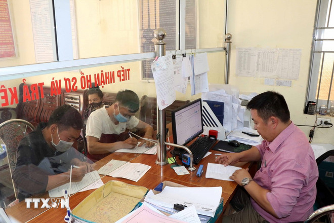 Locuitorii orașului Thuan Chau (provincia Son La) se înregistrează pentru asigurări sociale voluntare la agenția de asigurări sociale. (Foto: Huu Quyet/VNA) ttxvn-bao-hiem-xa-hoi3.jpg