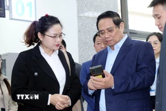 Thủ tướng Phạm Minh Chính ghi nhận đánh giá chất lượng dịch vụ công từ người dân. (Ảnh: Văn Đức/TTXVN)